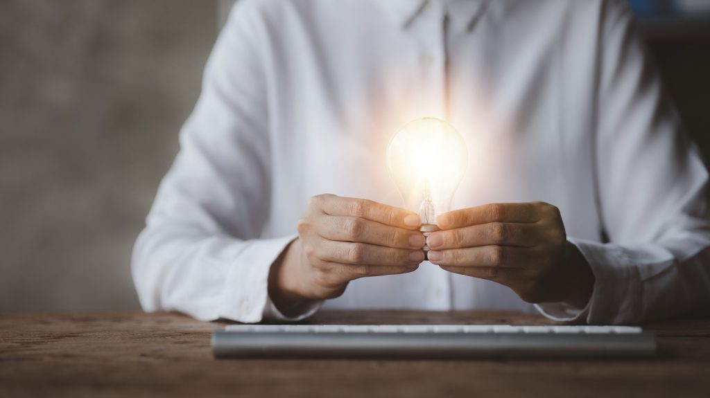 Woman holding a light bulb