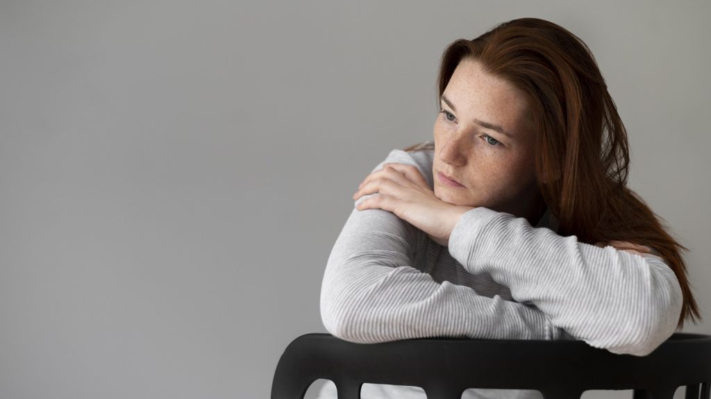 Sad woman sitting on a chair